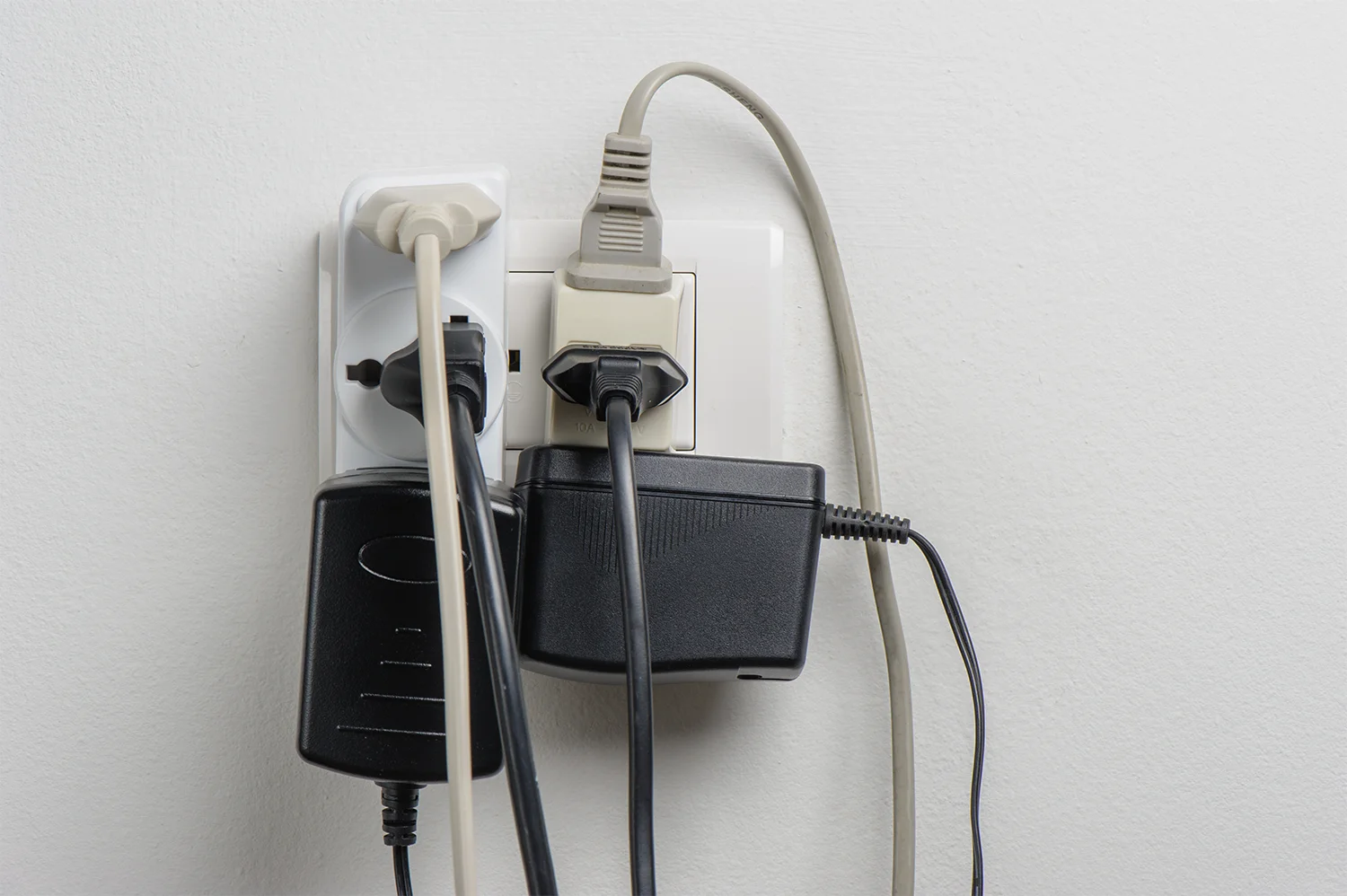 Multiple plugs plugged into one outlet - an example of a home electrical hazard.