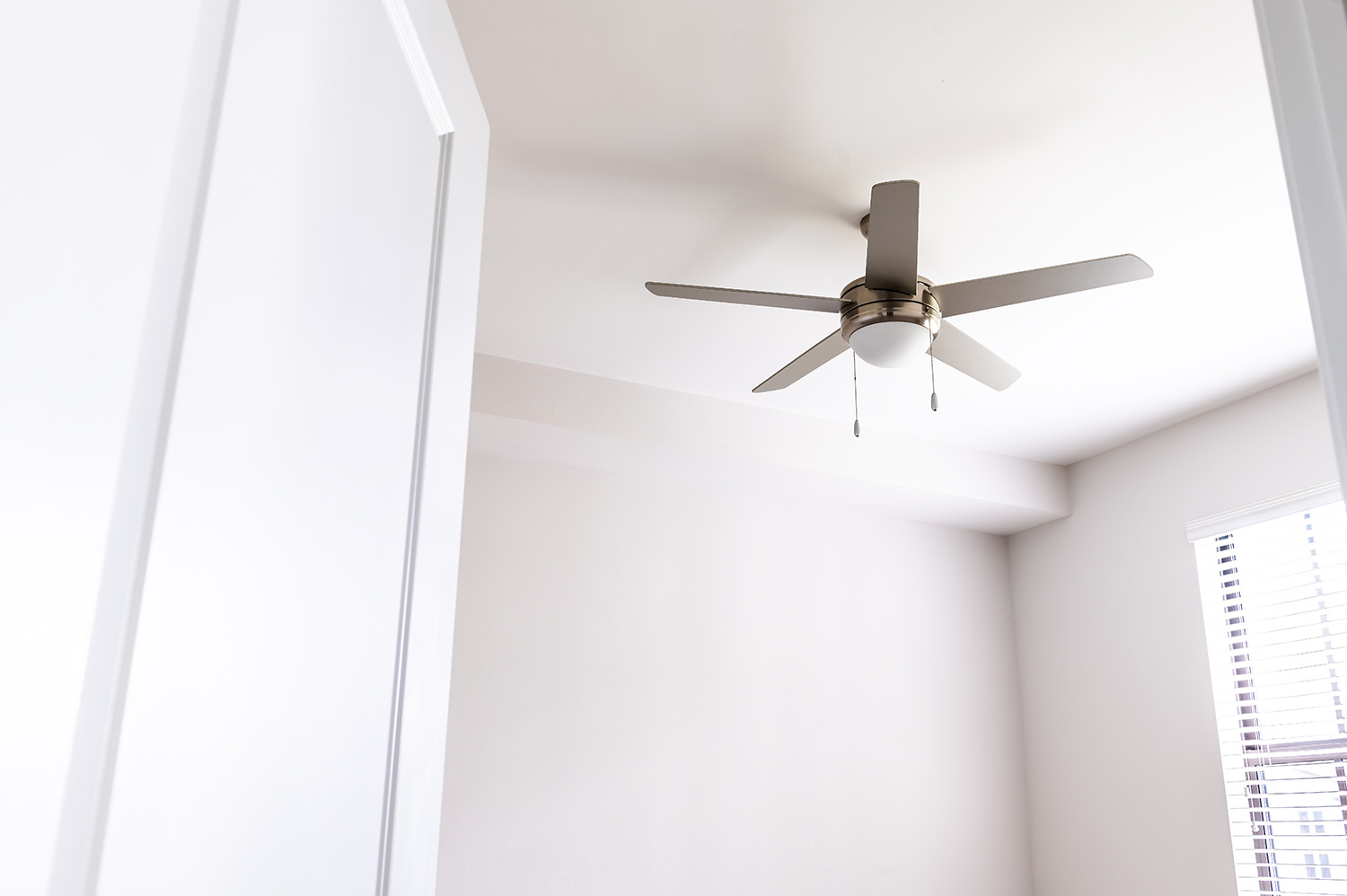 A chrome ceiling fan in a white room in Tennessee.
